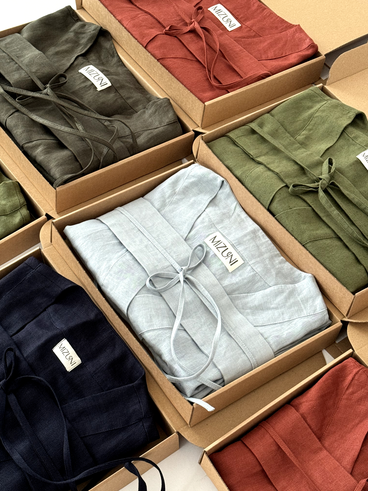 a picture illustrating several linen kimonos of different colours. the brand was developed by 360growthlabs