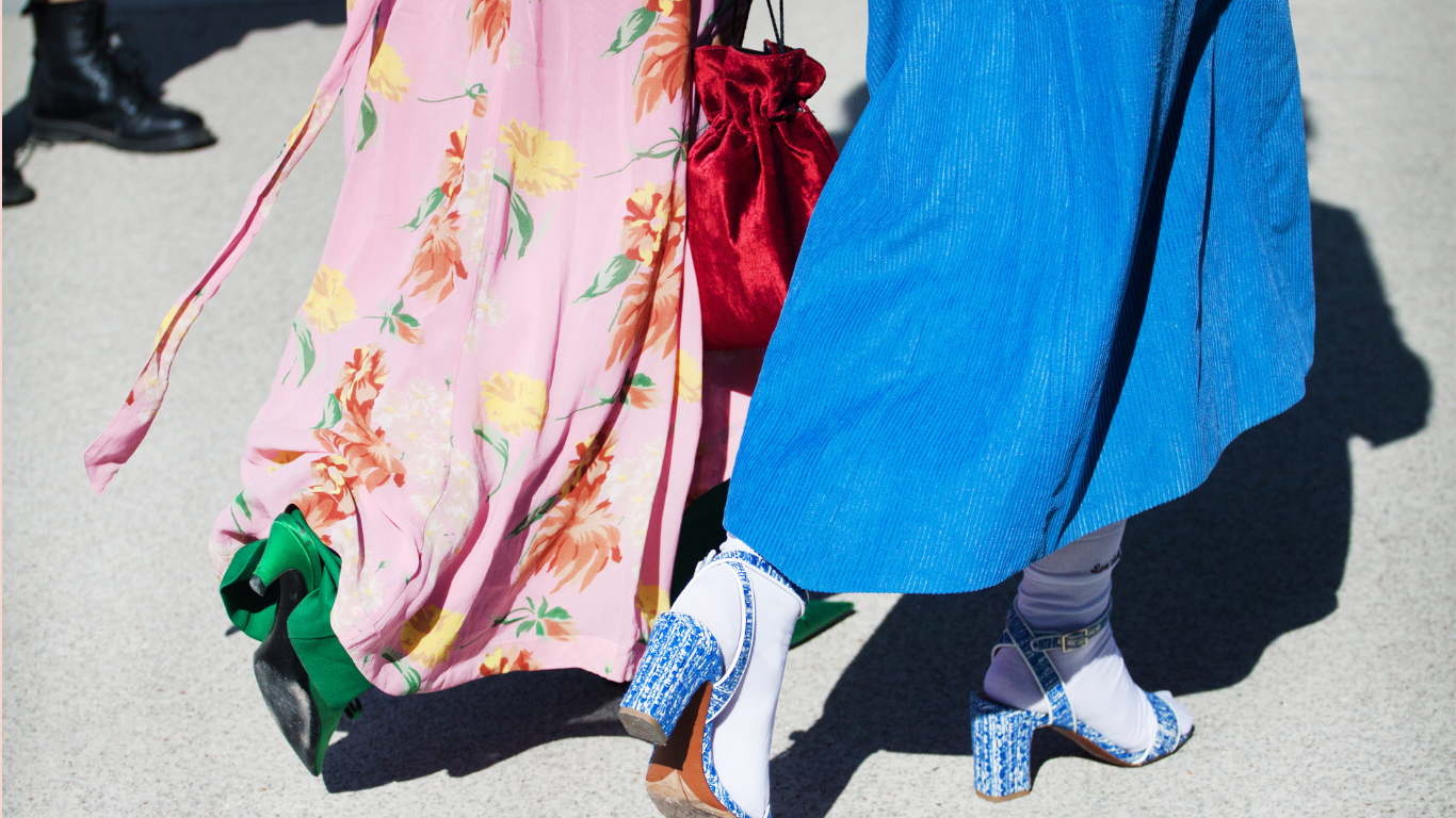 Close-up of colorful stylish long skirts paired with elegant heels, capturing modern feminine fashion.